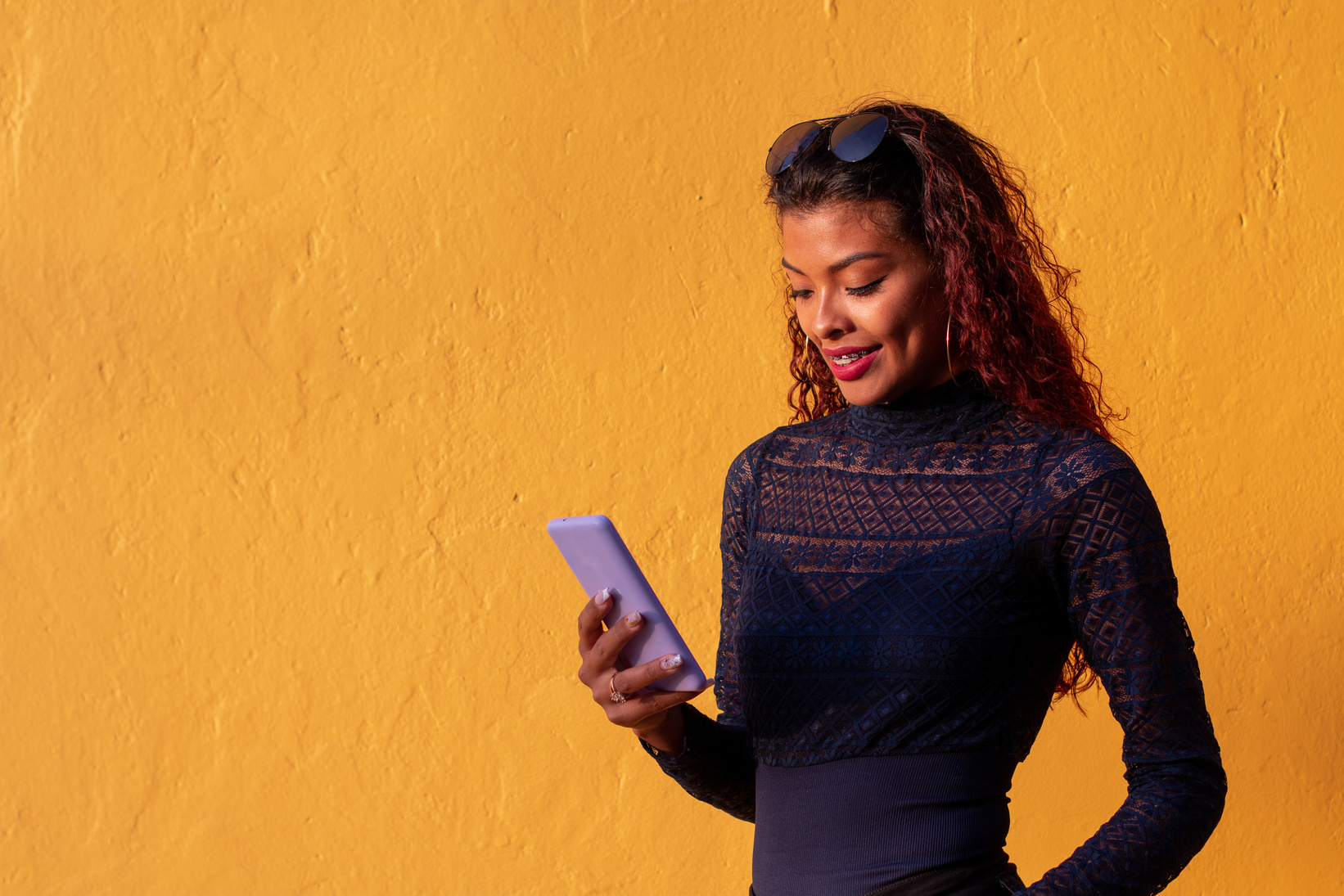 Black woman looking at her cell phone on summer vacations